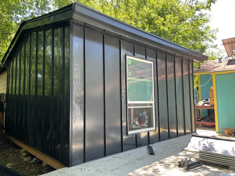 Black standing seam metal wall panels for Metal Roof Installation in Navarre