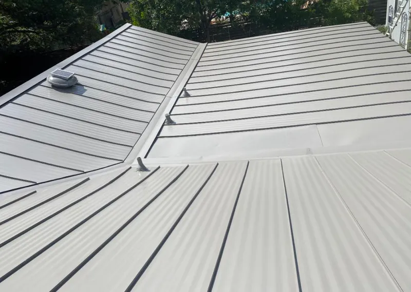Solar attic fan installed on a metal roof for Roof Ventilation in Navarre